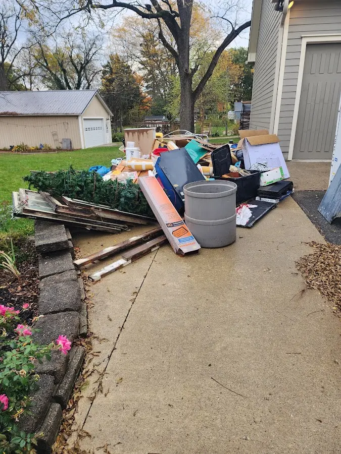 Dumpster being loaded with debris for Estate Cleanout Dumpster Rental in Estelle
